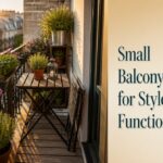 A small balcony with a bistro set, potted plants, and decorative lighting.